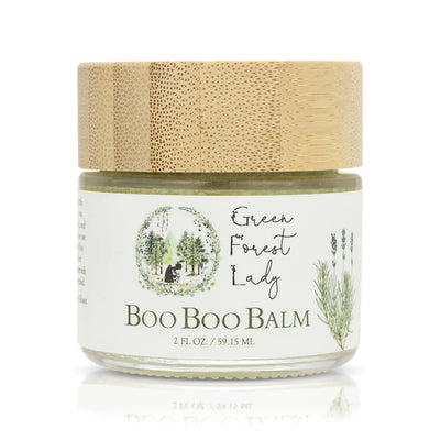 Green Forest-Organic Boo Boo Balm in a jar with a bamboo lid, ideal for soothing minor skin irritations.
